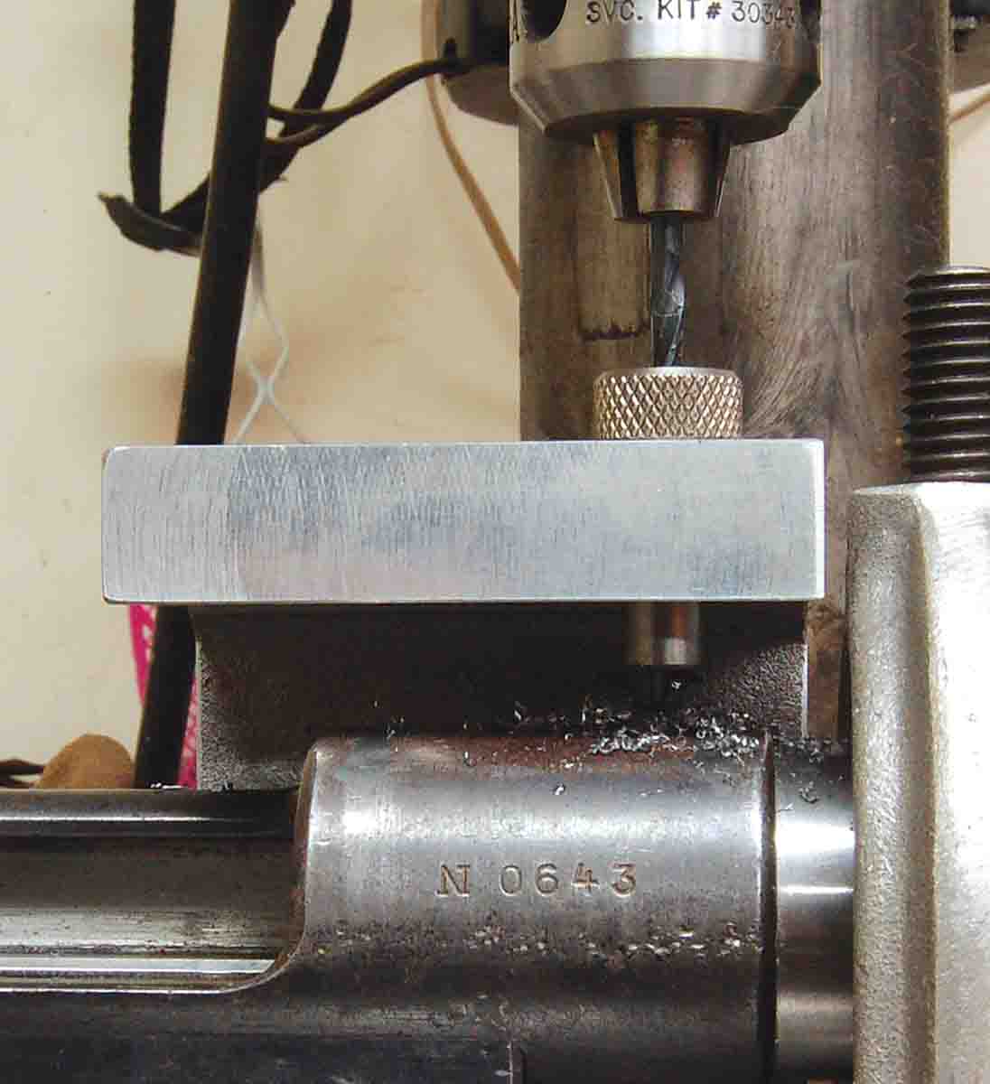 Drilling the receiver ring to attach a Picatinny rail. The drill jig is by Forster Products.